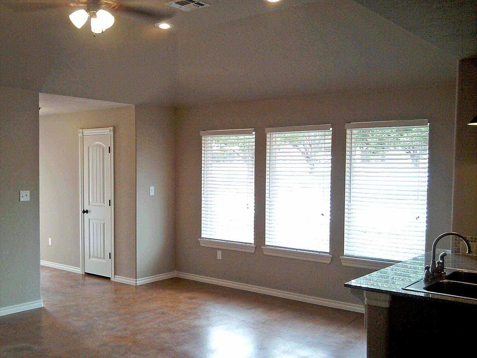 Entry closet, ceiling fan, and large windows in the Great Room.