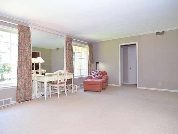 Carpeted living room with hardwoods underneath