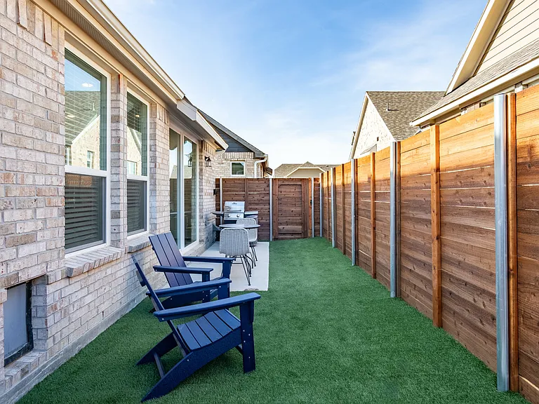 Embrace the convenience of your new home, where pet doors grant your furry friends easy access to their very own fenced-in yards.