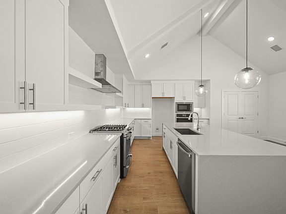 Kitchen with sleek pendant lighting