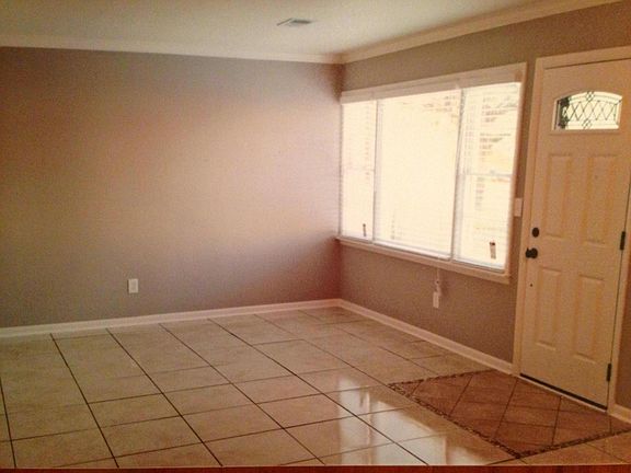 Open floor plan for living/dining area. Note the tile floor that extends into the dining and kitchen area.