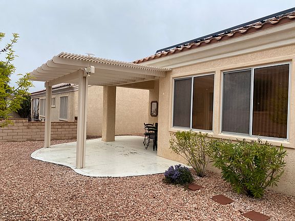 Covered patio with pergola, concrete refinished recently.