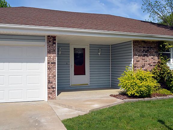 In Progress_Entry with covered Porch. Door to be replaced with new metal insulated door with miniblind in glass.