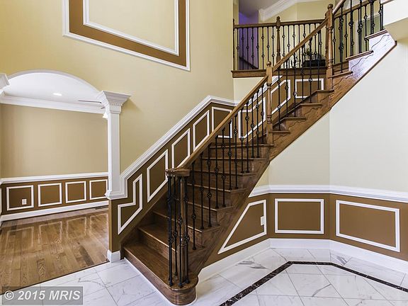 Inviting Foyer w/Marble Floors spiral staircase