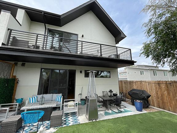 backside of home with balcony off the loft