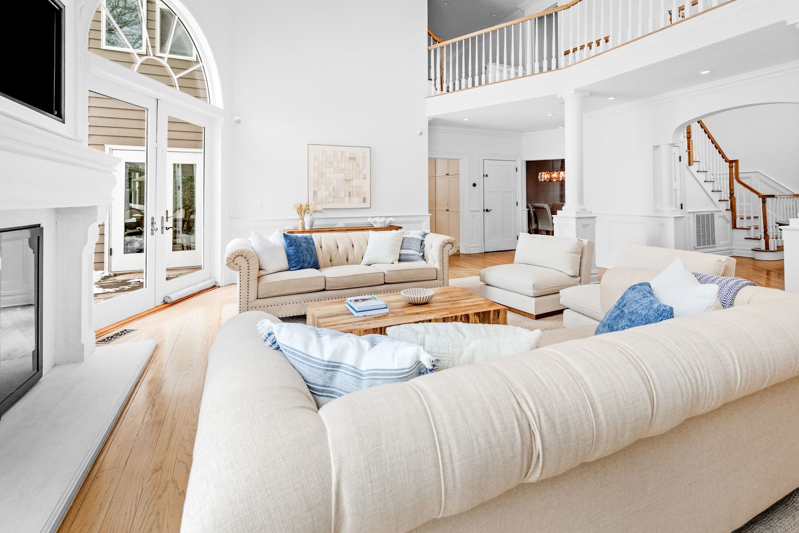  Grand living space filled with sunlight and dramatic ceiling heights