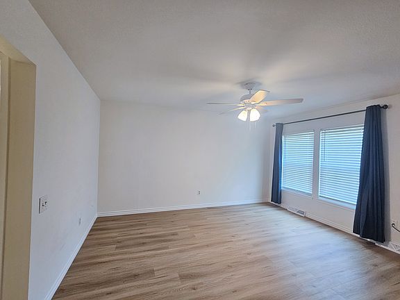 Master Bedroom Suite with spacious closets, fan, and blackout curtains
