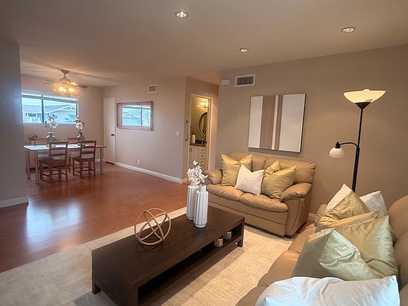 common area- Living room open to Dining room with wood flooring throughout