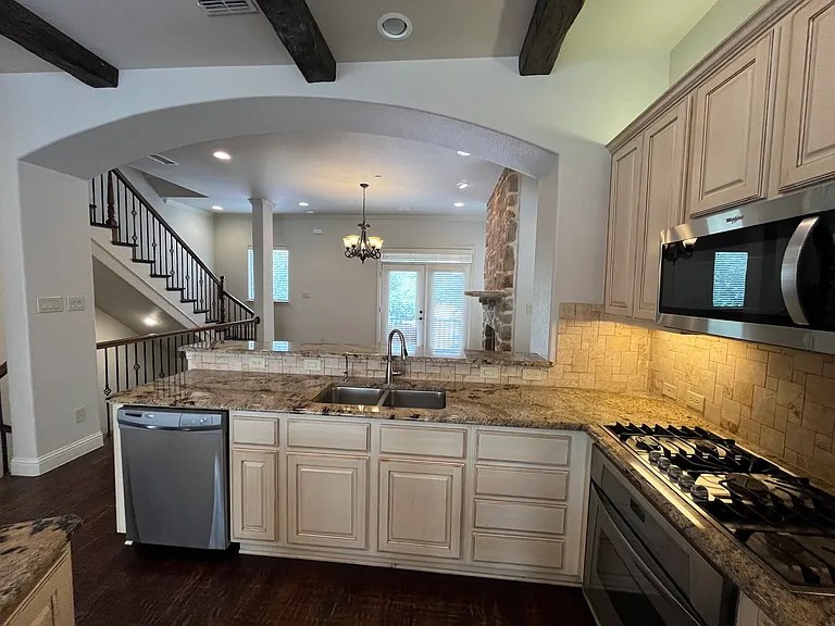 Beautiful kitchen with designer cabinets, high-end appliances, and refrigerator