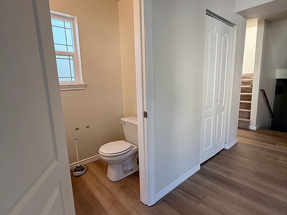 stairs leading up from the main entrance and stairs leading up to the third floor. half bath in living space.