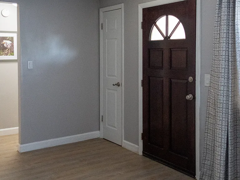 Welcome to your new home with a beautiful solid wood front door.