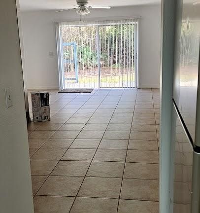 Kitchen looking through dining and living room to back yard