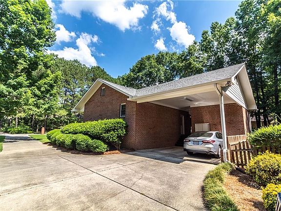 Double Carport with large storage room and plenty of parking.