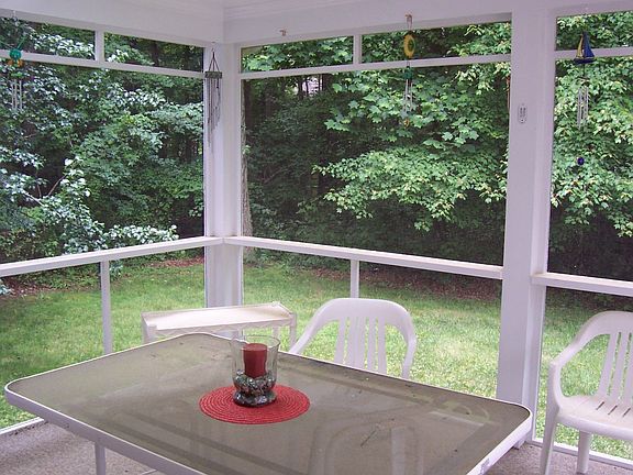 Screen porch overlooking private backyard