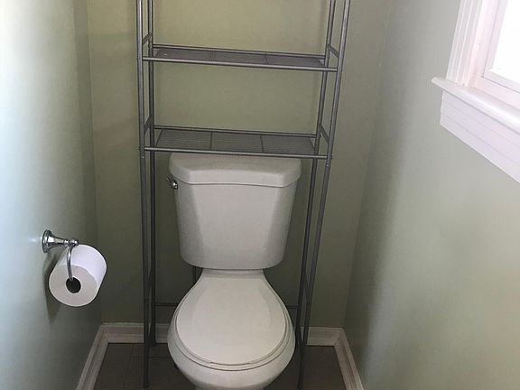 1/2 bathroom with vanity and toilet