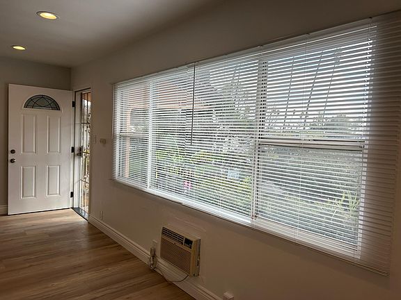 Upper unit view of front door and neighborhood from dining room
