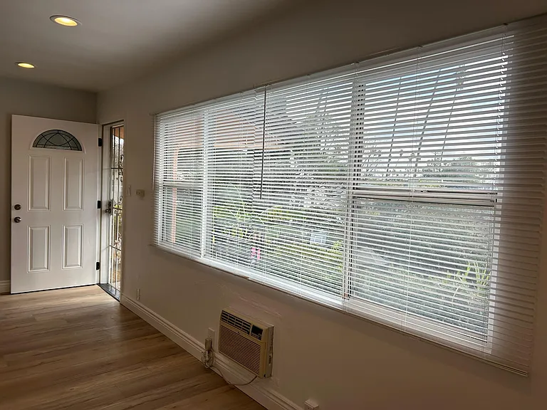 Upper unit view of front door and neighborhood from dining room