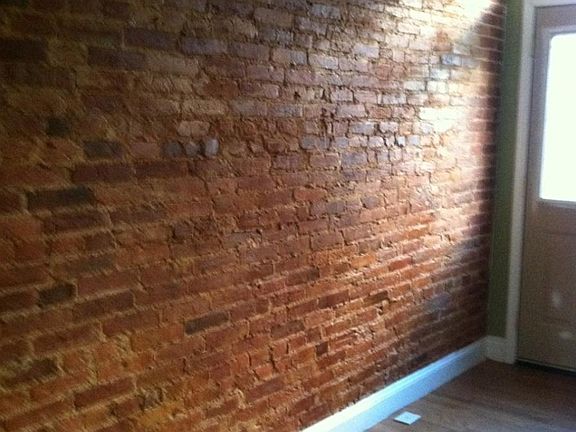 exposed brick wall in living room