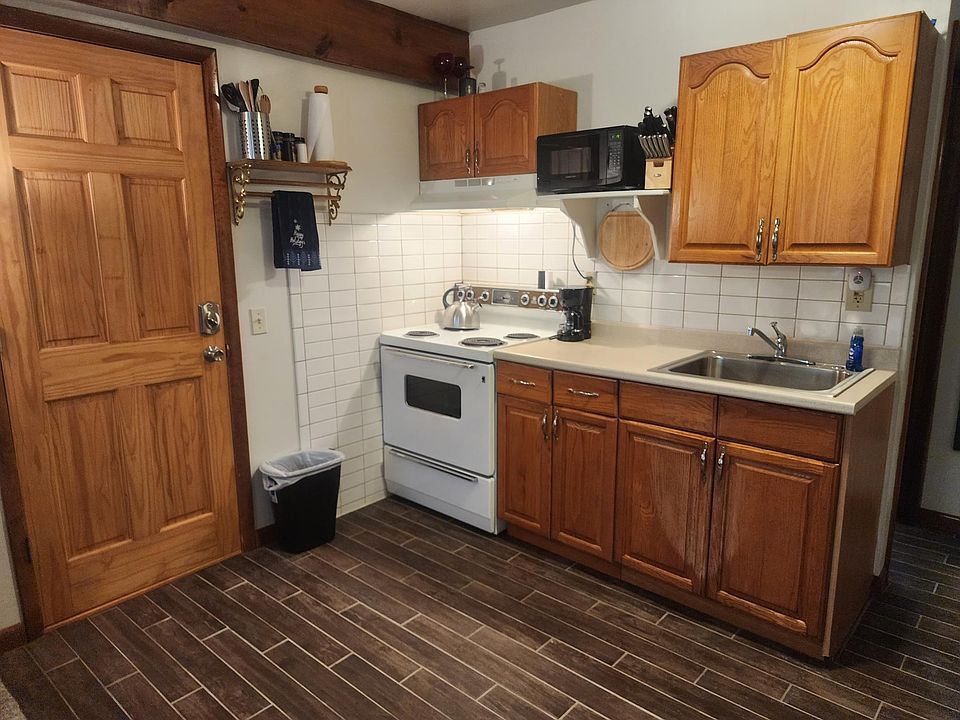 Kitchen area with new tile floor and tile back splash