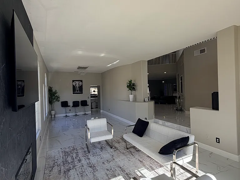 Additional perspective of the fireplace seating area and adjacent open space.