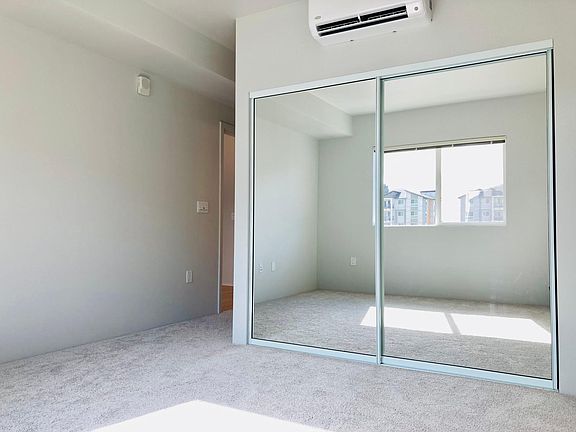 Bedroom with split A/C unit and closet