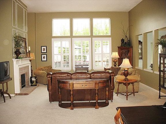 Open vaulted great room with fireplace & wall of windows!