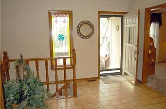 Gracious entry with ceramic tile floor and gorgeous faux stained glass picture window