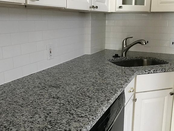 Kitchen with newly installed granite counter tops, backsplash and new appliances