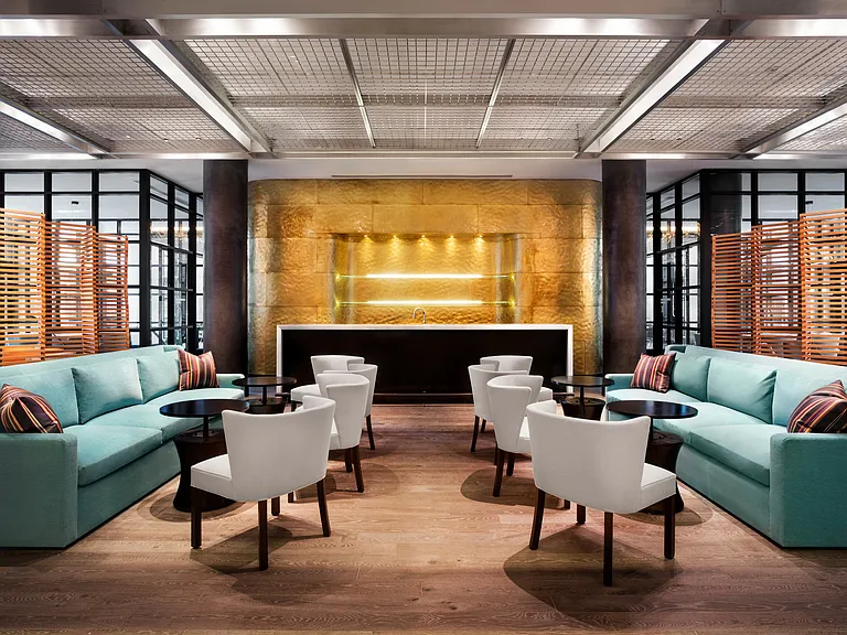 Oversized resident clubroom with bar and lounge seating