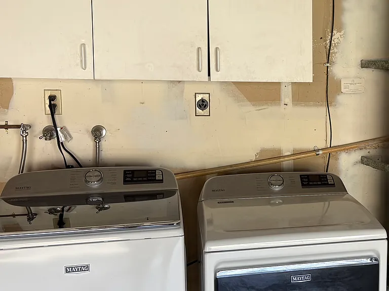 Maytag washer and gas dryer in garage.