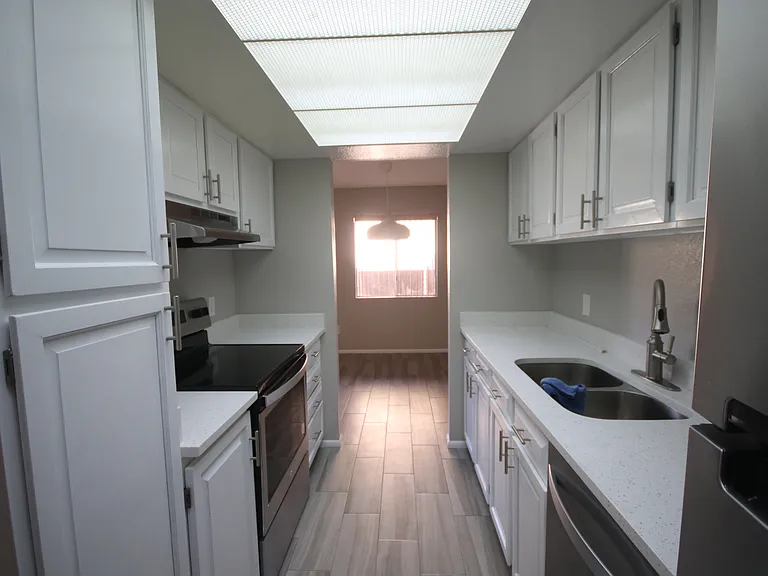 A view from your well-appointed kitchen with stainless steel appliances: microwave, range, oven, double sink, dishwasher, refrigerator, and lots of cabinet space. Note. Landlord is purchasing a counter top microwave prior to your move-in.