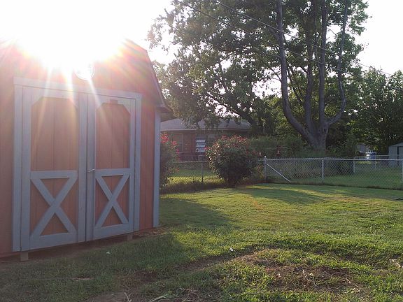 Fenced backyard with shed