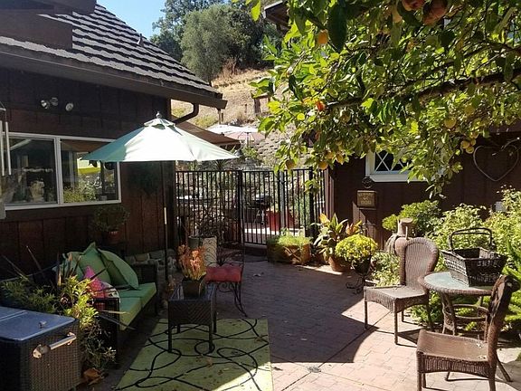 This photo also taken from the driveway shows the main home on the left and the in-law unit on the right (hidden behind the lemon tree). The two buildings are completely separate.