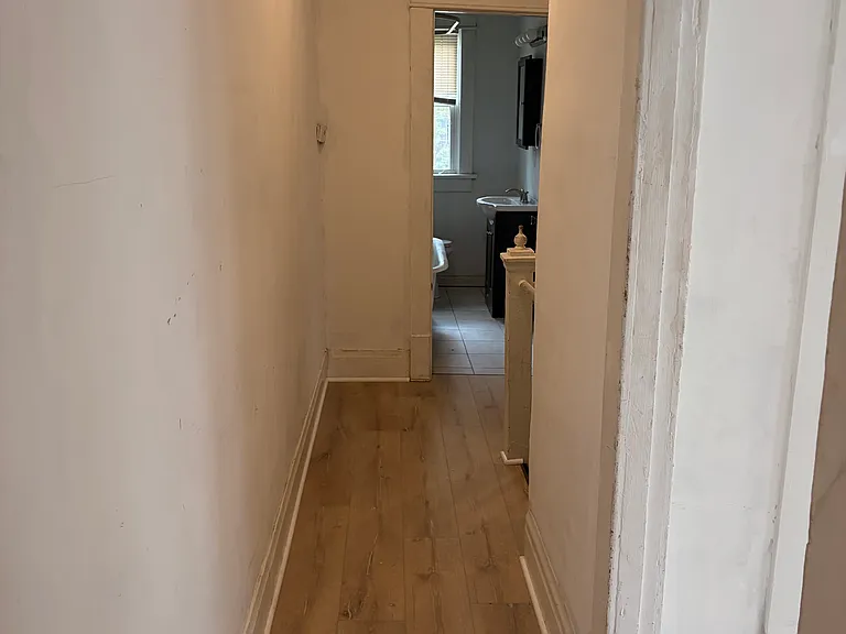View when you walk into apartment. Living room and bedroom are to the right. Hallway leads to bath, kitchen and stairs to upstairs bedroom and washer/dryer.