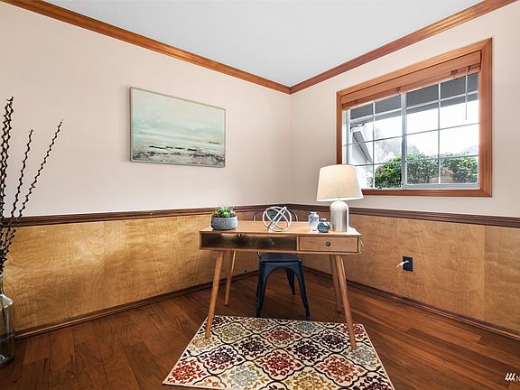 Convenient main floor office with newer flooring and custom wainscoting. >