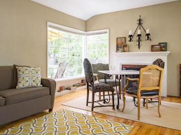 Living room with cozy, fireplace, dining area