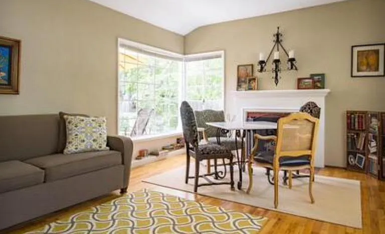 Living room with cozy, fireplace, dining area