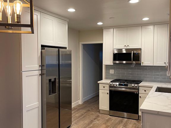 New kitchen; stainless dishwasher, stove and fridge. can lighting