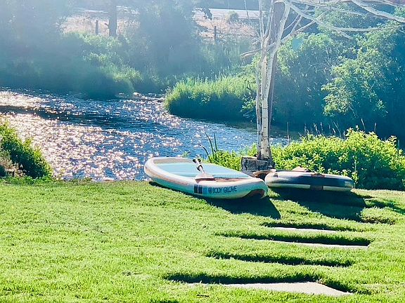 The river is perfect for paddleboarding, kayaking, floating, fishing... or just watching. The river is easy to walk into for a quick dip or to take a water toy in.