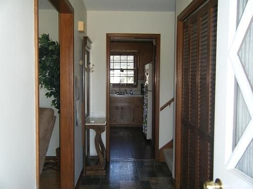 Living room on left and hall closet and stairs to upper leve