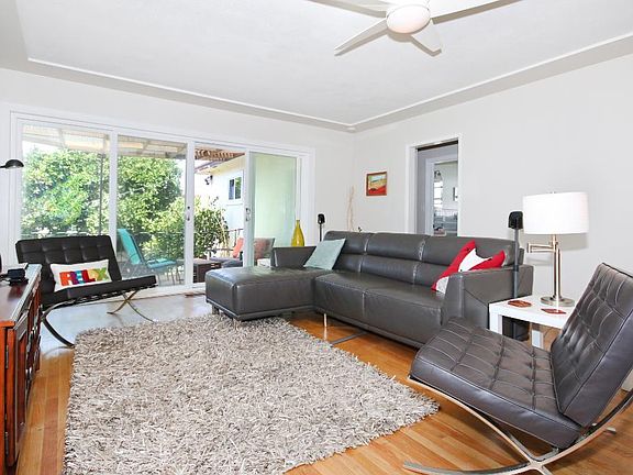 Living Room with sliding glass doors that open to patio and backyard