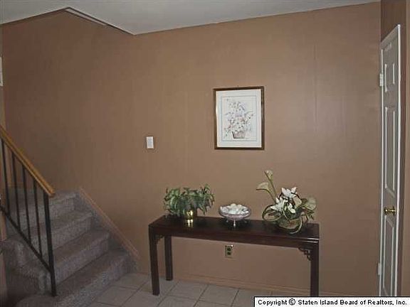 Entry foyer with stairs up to main apartment. 