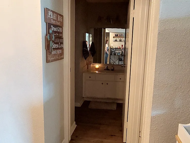 Hall leading to guest bathroom and second bedroom