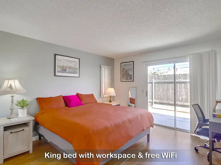 Spacious room with a king bed and dedicated workspace for ultimate comfort.