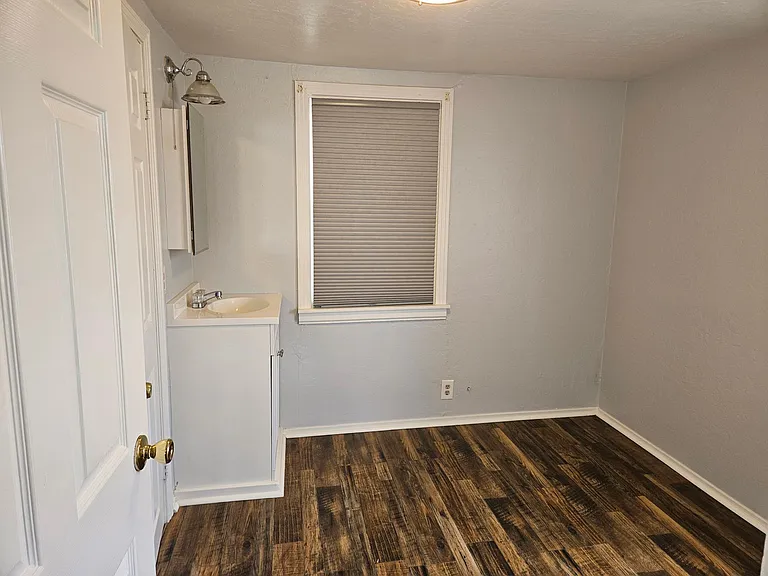 Small room between bedroom and bathroom with sink. Could be used as small office, dressing room, etc.