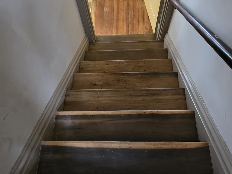 View down the front staircase onto the living room landing.