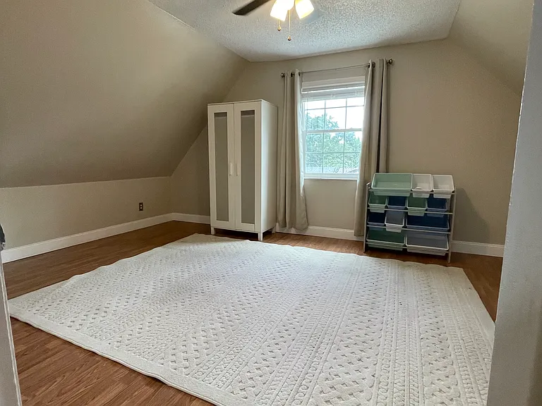 third bedroom with closet and armoire