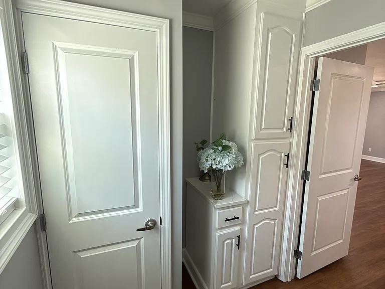Laundry room cabinets and water heater closet.