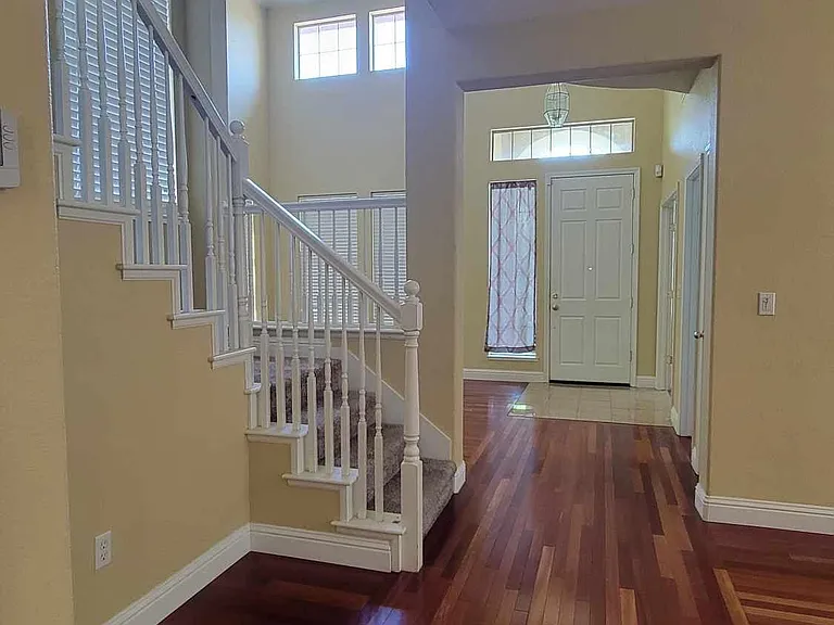 View from kitchen towards front door - dining room off to the right, opposite staircase