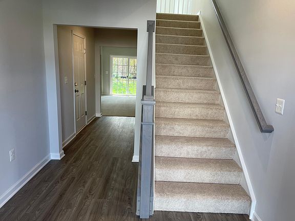 After Entrance, entry to Den and Bath and Stairs to Main Level